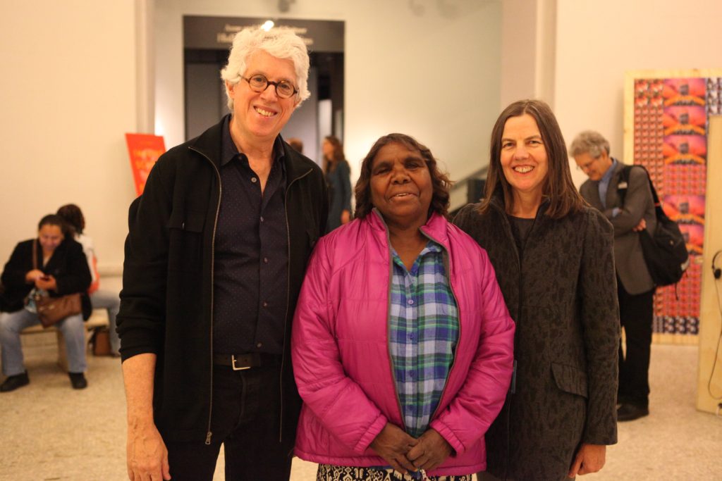 Fred Myers, Marlene Nampitjinpa Spencer, and Pip Deveson in the lobby of the American Museum of Natural History for the screening of Remembering Yayayi.  October 2014.  (The installation of Gapuwiyak Calling is in the background).  Photo credit:  Francoise Dussart.